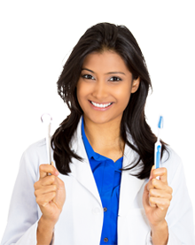 female dentist wearing lab coat, holding a toothbrush and a flossing tool.
